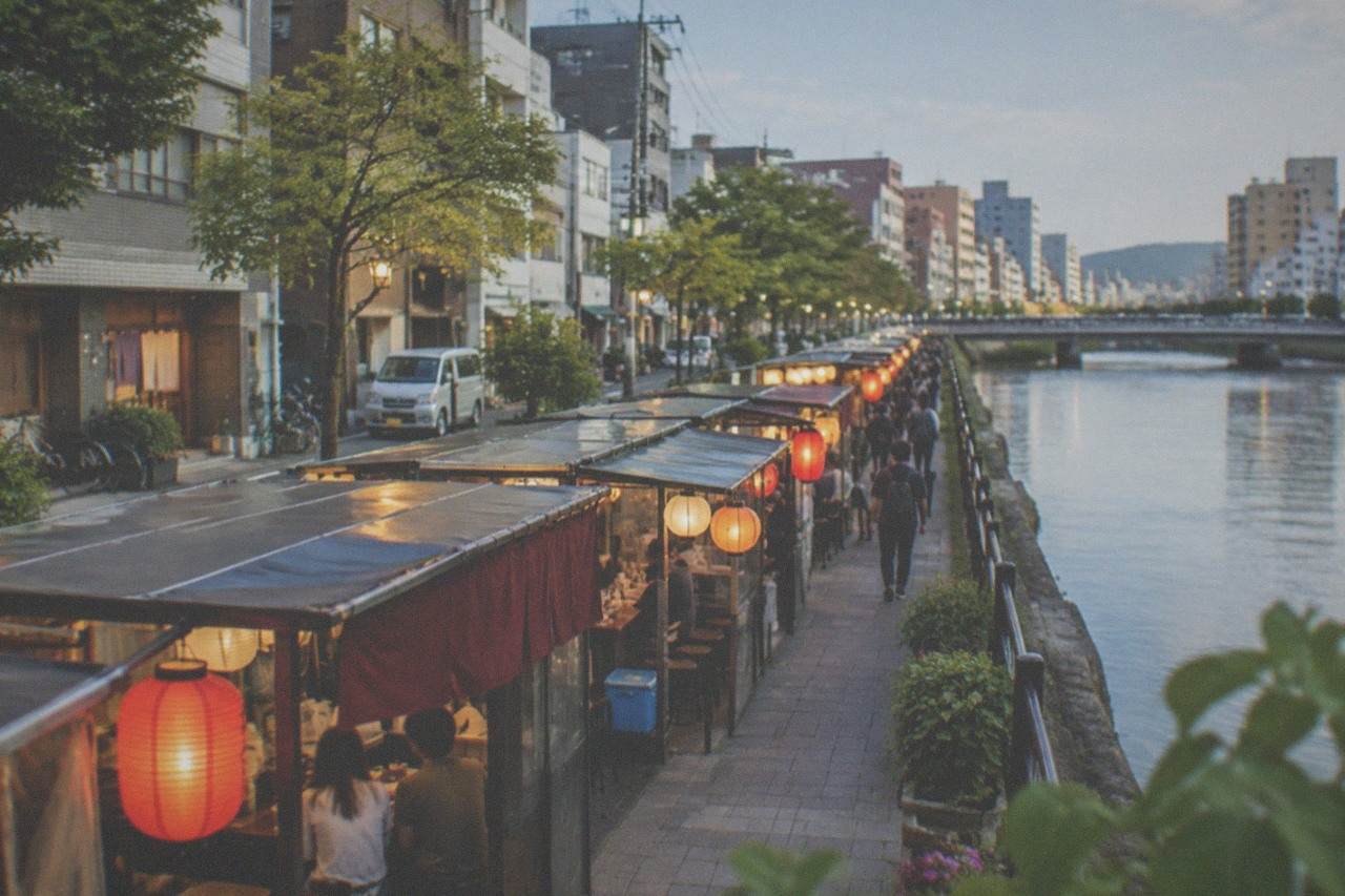 Illuminated street stalls lined up along the Naka River in Fukuoka at night