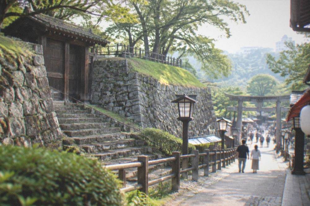 Lantern-lined shrine approach with a torii gate ahead
