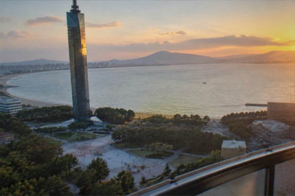 A panoramic view from the upper deck of Fukuoka Tower across Hakata Bay at dusk