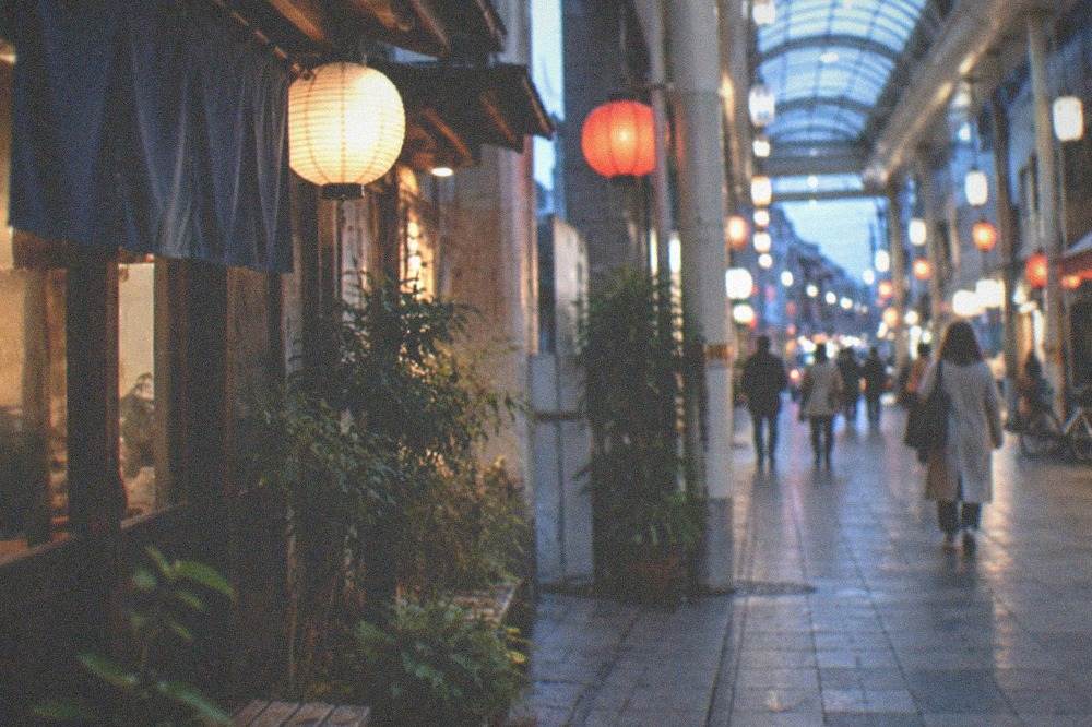 Covered shopping arcade street with lanterns and small shopfronts in Hakata
