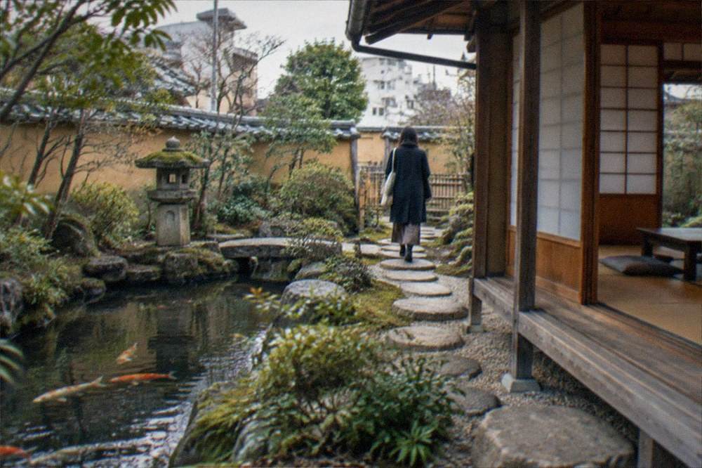 Tatami room interior with a low table and a view through paper screens to the garden
