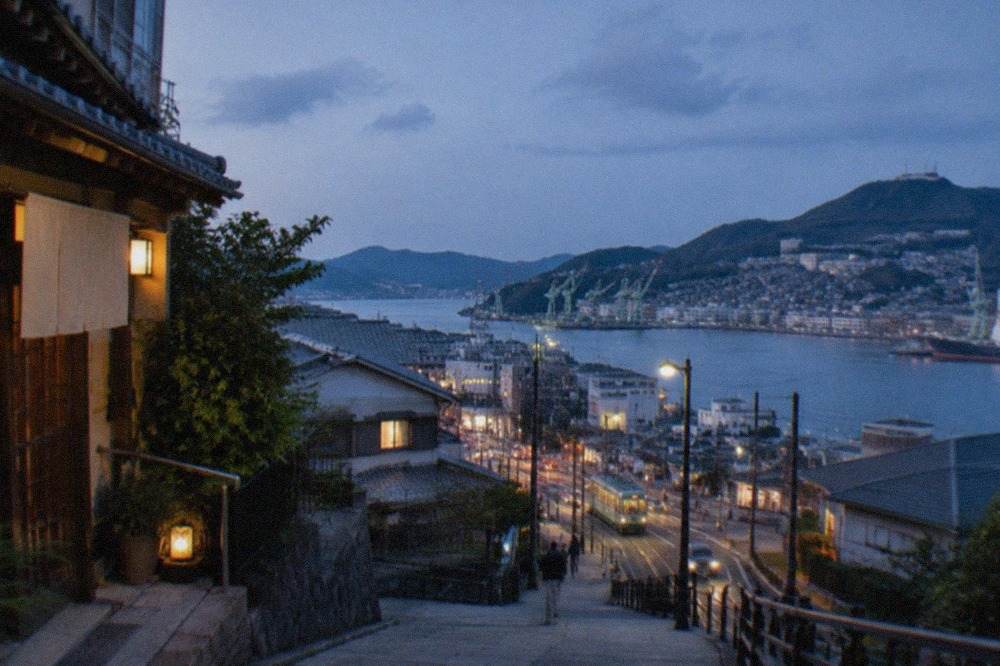 Harbour city skyline of Nagasaki with green hills rising behind the water