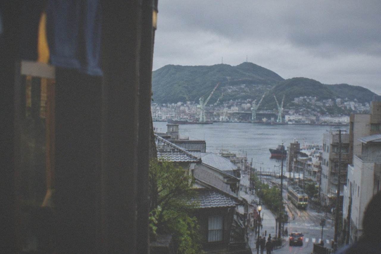 Harbour city skyline of Nagasaki with green hills rising behind the water