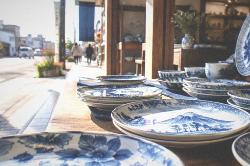 A display of hand painted blue and white porcelain plates inside a bright ceramics shop
