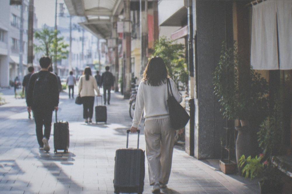 Passengers with luggage walking through an airport arrivals corridor