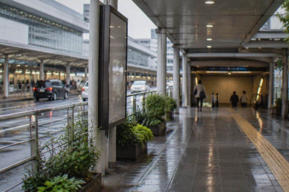 Fukuoka Airport terminal exterior with a covered walkway leading to a subway station entrance