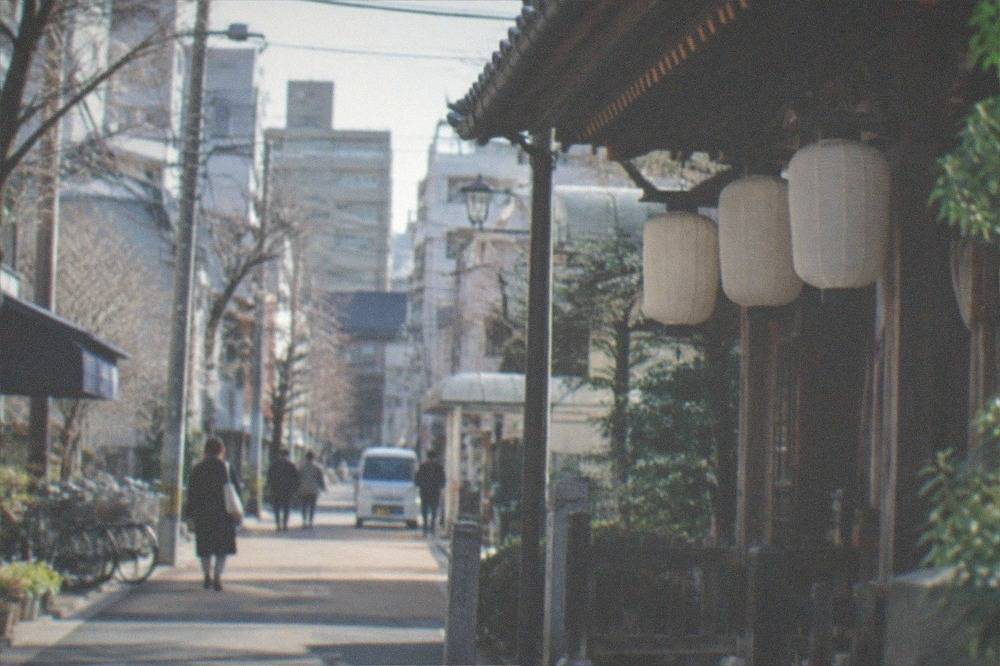 Wooden temple hall with lanterns hanging under the eaves