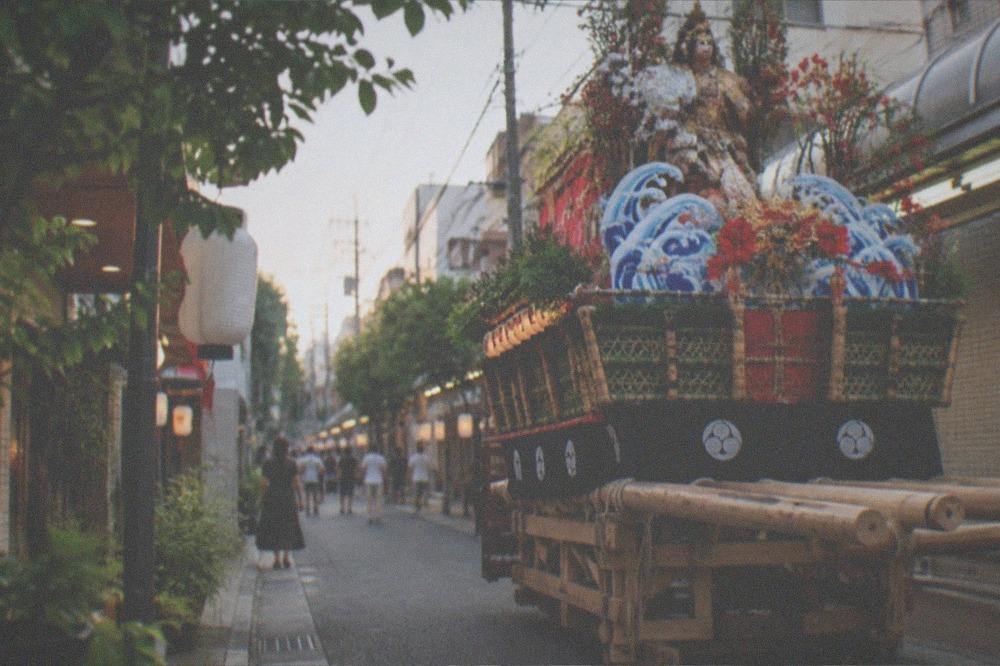 Ornately decorated Yamakasa festival float displayed on a Hakata street at dusk