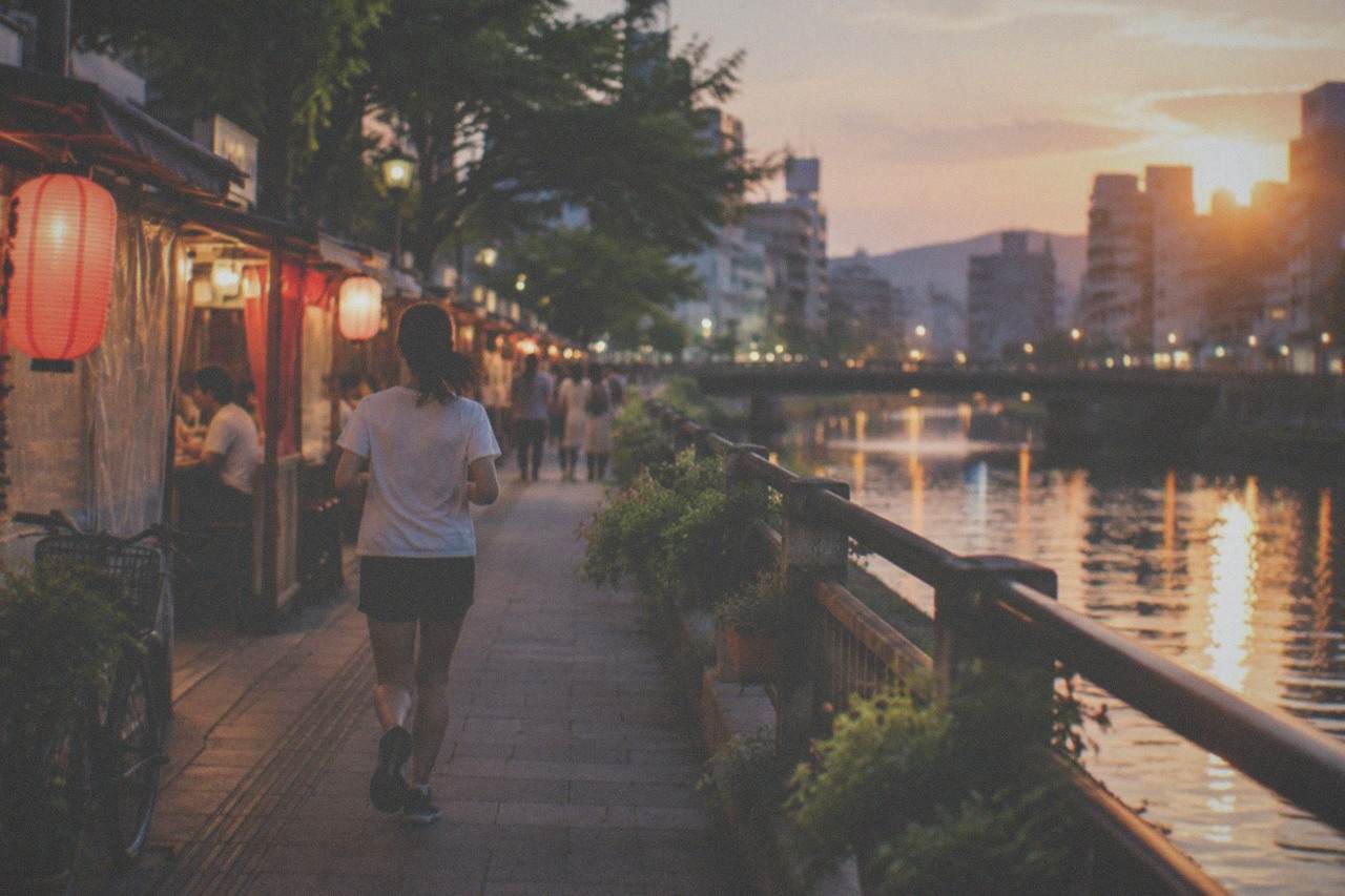 Summer evening along the Naka River with illuminated food stalls reflected in the water
