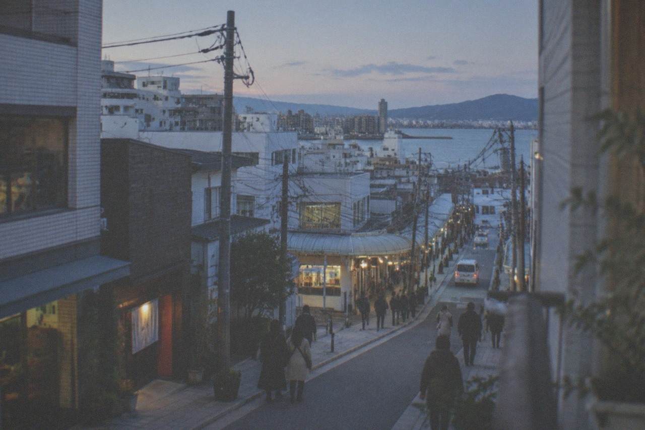 Fukuoka city skyline on a clear winter day with Hakata Bay and distant hills in soft light