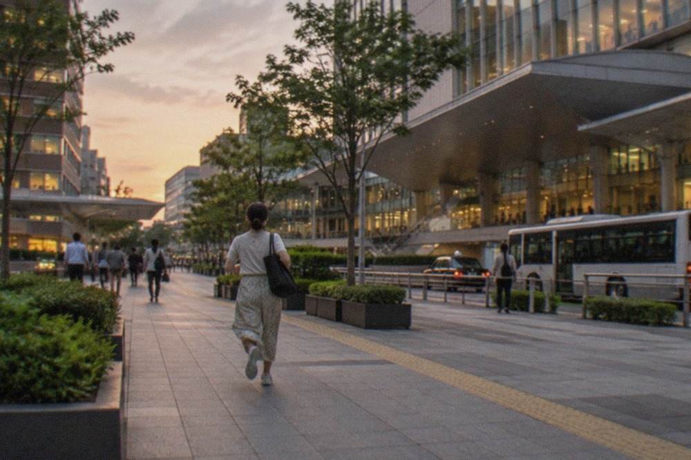 Hakata Station exterior at dusk with illuminated signage and city buildings