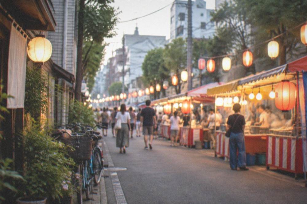 Festival night street lined with food stalls glowing under strings of lanterns