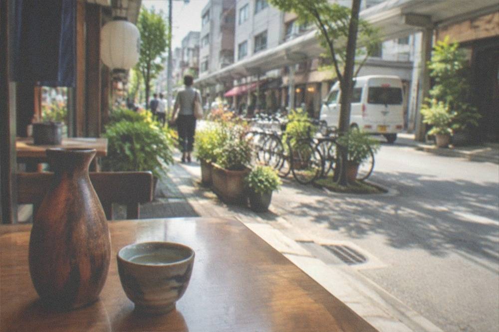 A wooden tokkuri flask of warm sake beside a small ochoko cup on a restaurant table