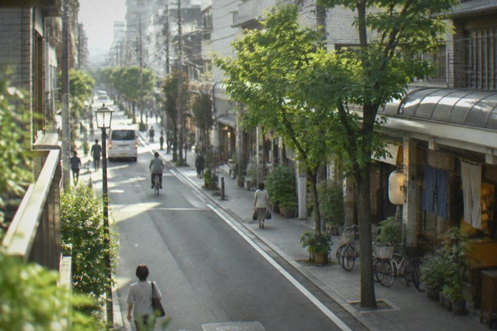 A quiet hotel street near Hakata Station with a subway entrance sign