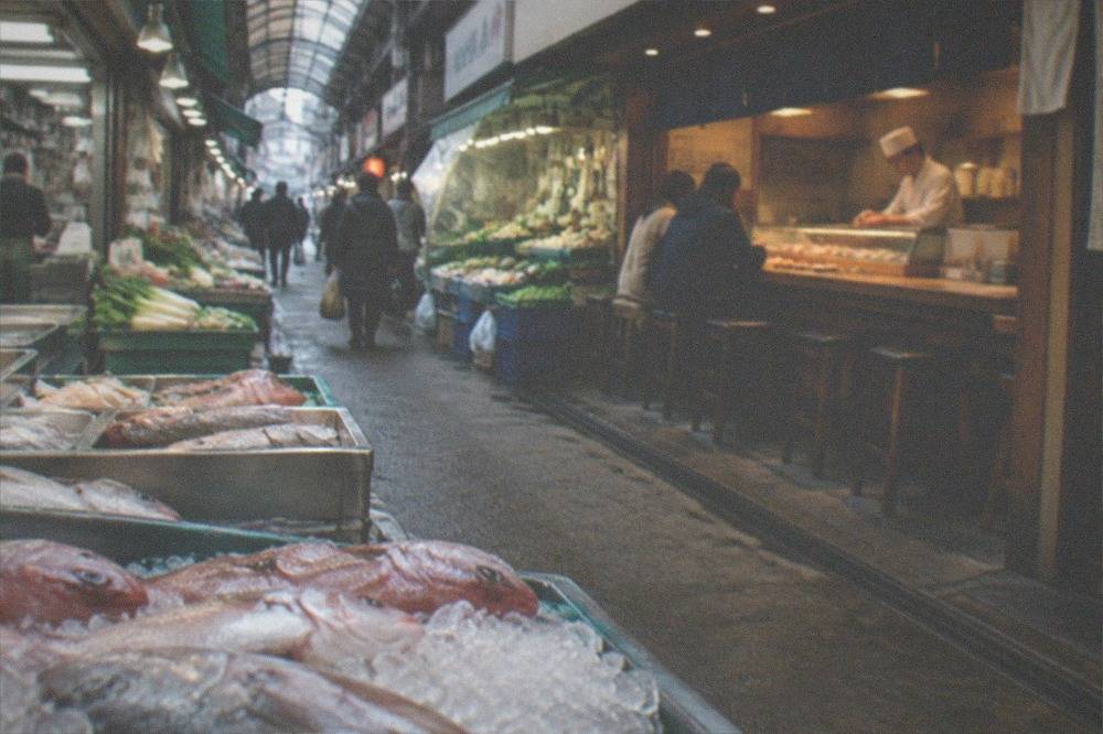 A standing sushi bar with a chef preparing nigiri for customers at a wooden counter