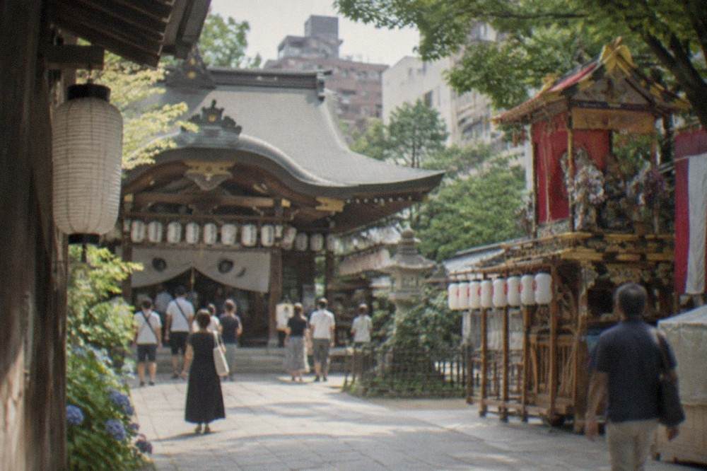 Kushida Shrine's main hall with lanterns and a decorated festival float beside it