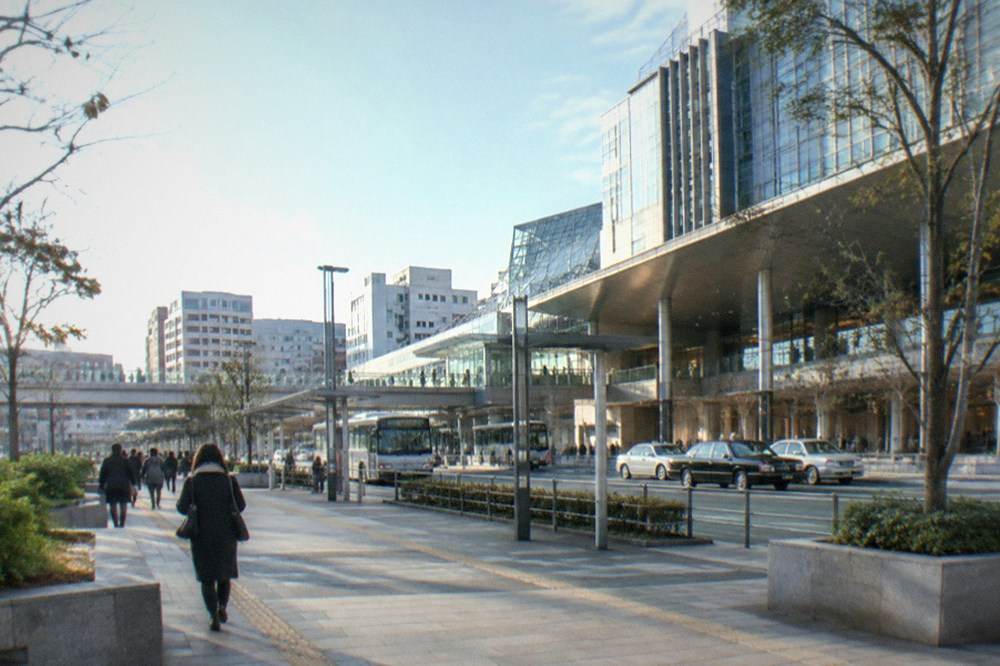 A clean modern subway platform with a train arriving at a Fukuoka station