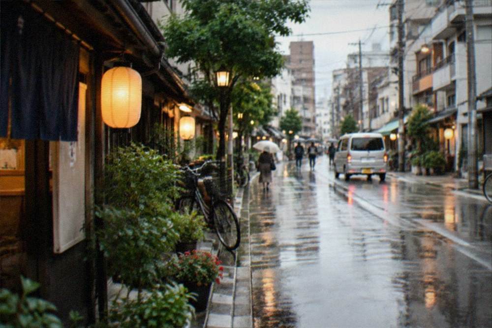 Rain-slicked street in a Japanese port city with lanterns reflecting on wet pavement