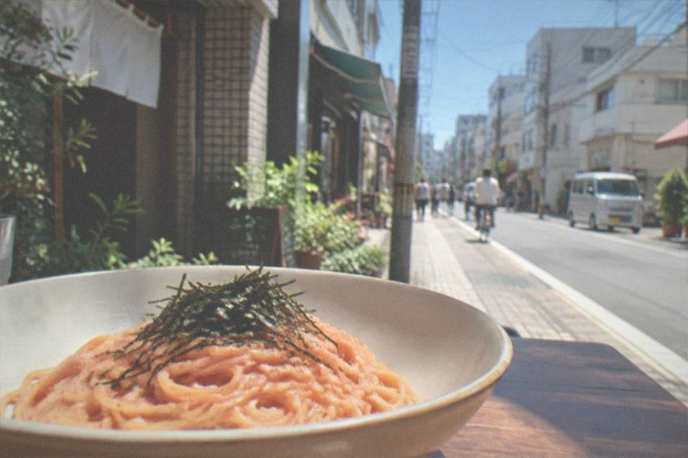 Bowl of pink mentaiko cream pasta garnished with shredded nori