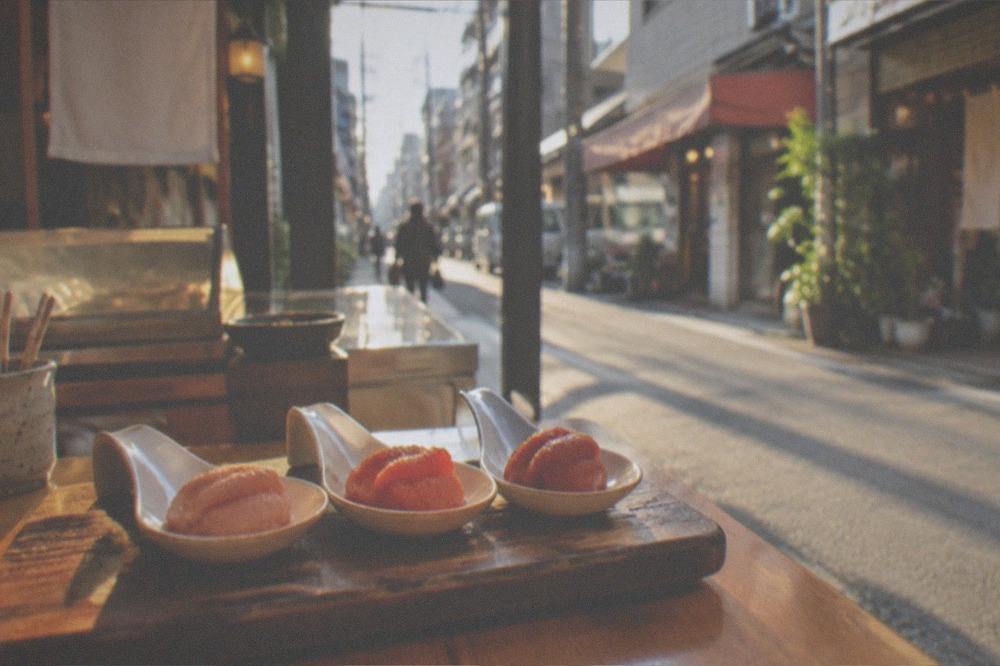 Tasting spoons with three shades of mentaiko on a shop counter