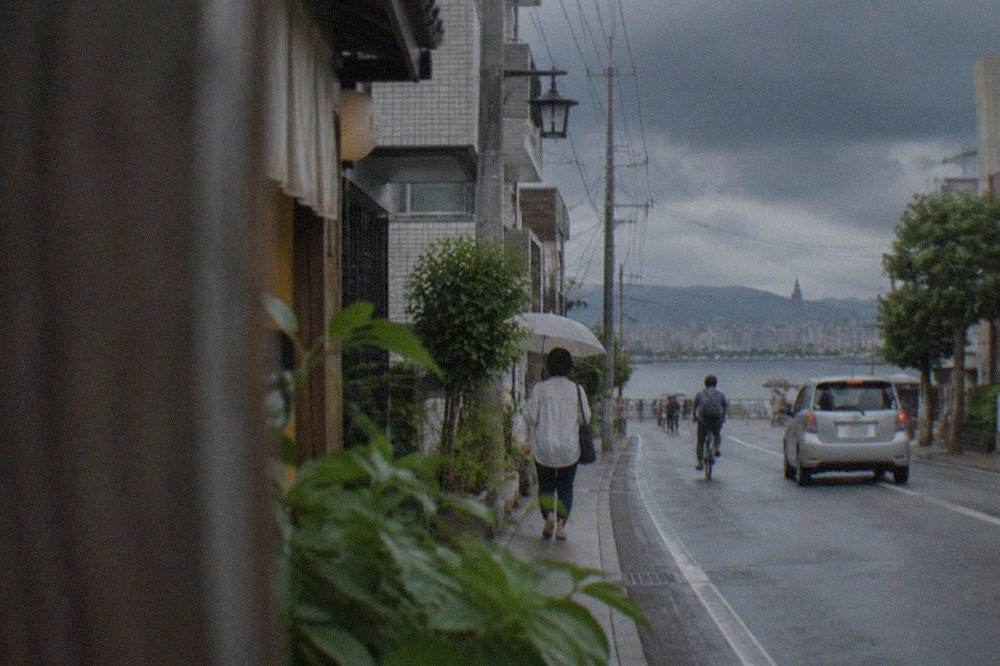 Dark storm clouds gathering over Hakata Bay and the Fukuoka city skyline