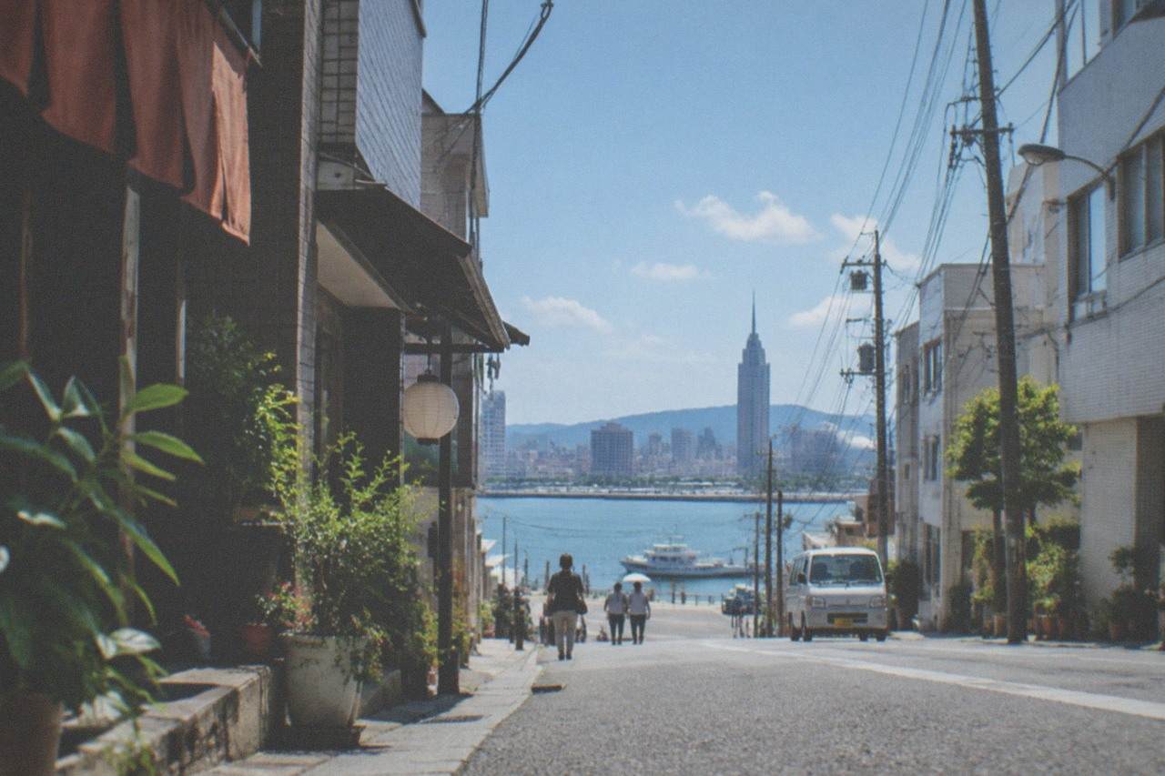 Fukuoka city skyline across Hakata Bay with tall buildings and a calm harbour in the foreground