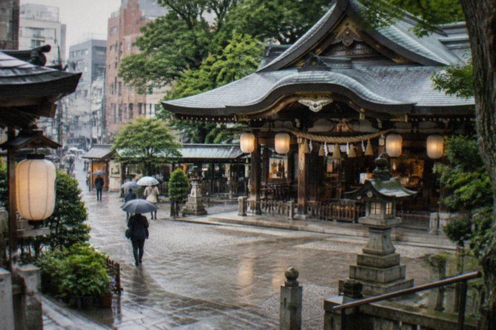 Kushida Shrine's main hall beneath lanterns and cedar trees in central Hakata