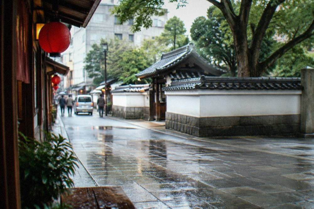 Red lanterns and traditional wooden facades along a Hakata old town street in late afternoon light