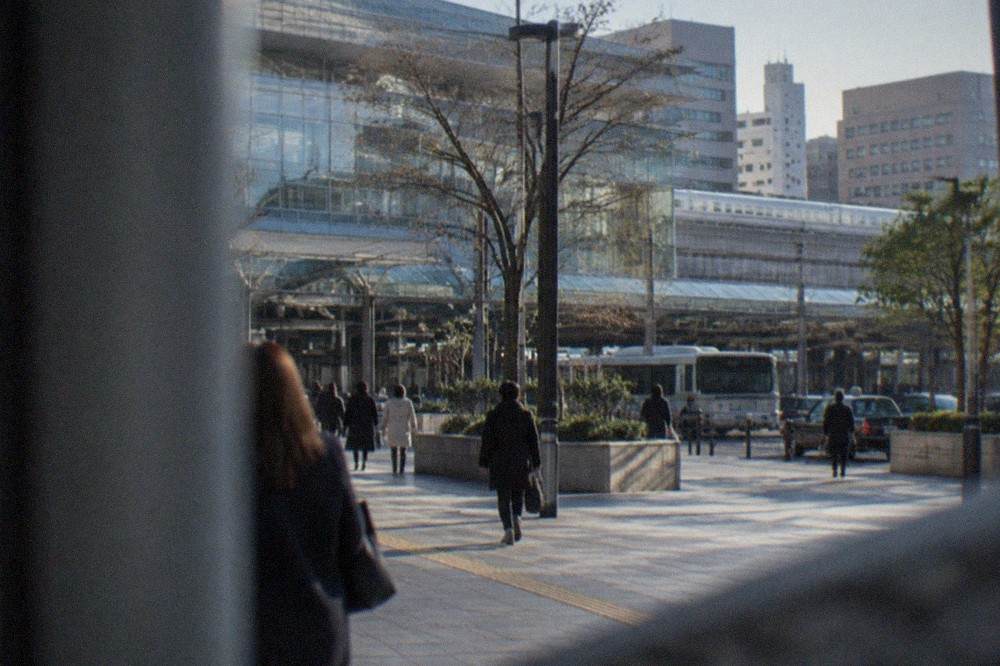 Hakata Station exterior with the Shinkansen tracks and city towers behind it